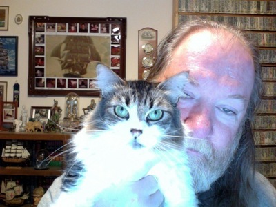 This is my beloved husband and one of 5 cats! This one is Lucy, a long-hair with huge green eyes!