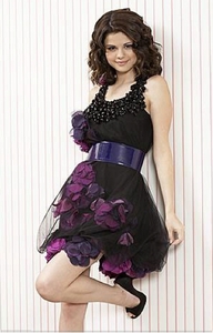 Here is she in an outfit: http://www.taramtamtam.com/wallpapers/Music/S/Selena_Gomez/images/Selena_Gomez_26.jpg

And here is she in a cool dress:

So chouse one who you like!!<3<3<3<3