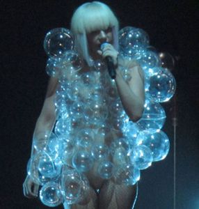 her outfit in that video is funny and a little creepy. the men are wearing speedos and tight jeans. it is crazy. i am giving her credit though for her outfits like the bubble dress and stuff