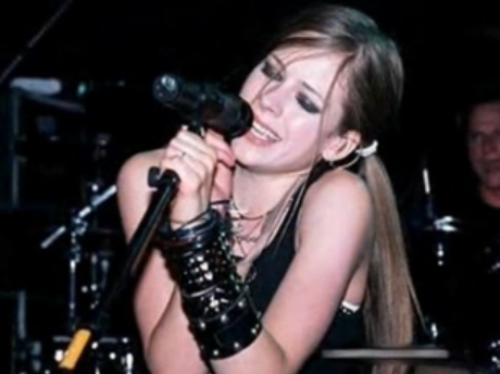 Avril started writing her own songs and playing the guitar in her early teens.

The first song that Avril ever wrote was called "Can't Stop Thinking About You". It's about a teenage crush, which she described as "cheesy cute". The song hasn't been released.
Apparently a song called Darlin' was another of Avril's first songs. It might be appearing on her 4th album due out soon!

Source: http://en.wikipedia.org/wiki/Avril_Lavigne

Hope that helped :) 
