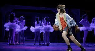 Billy Elliot in boxing gear with ballet girls