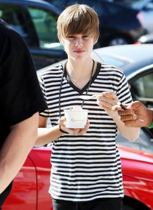 heres one of justin bieber eating ice cream. i want one of playing football 