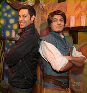 Here's Flynn & Zachary.

Now find any picture of Tiana/Naveen at Disneyland/World.