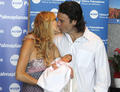 Carolina Cerezuela and Carlos Moya presented to Carla, her first child - tennis photo