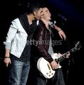 Joe Jonas biting Kevin Jonas's...uh...ear??? - the-jonas-brothers photo