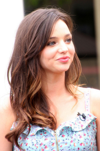 Miranda Kerr flaunts her post-pregnancy figure in a cutesy floral dress on "Extra" at the Grove
