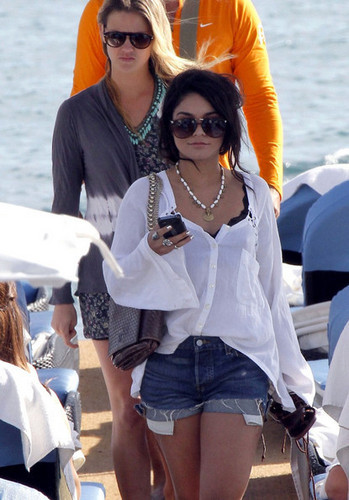  Vanessa Hudgens stays glued to her phone as she arrives at the Hotel Martinez.