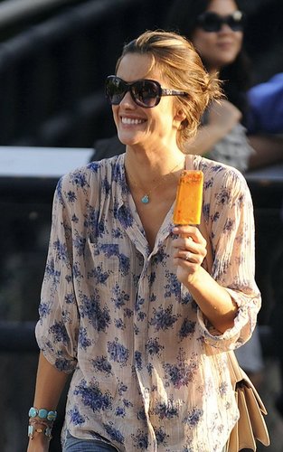 Alessandra Ambrosio cools off with a popsicle as she goes for a late afternoon stroll with familily