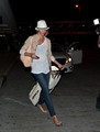 Cameron Diaz pulls a set of gravity-defying moves at LAX after a long and apparently fun flight.  - cameron-diaz photo