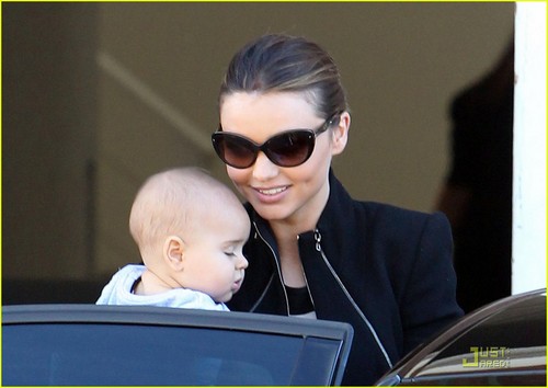 Miranda Kerr carries her 6-month-old son Flynn while leaving a photo shoot on Tuesday (August 2)
