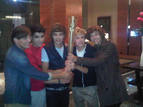  One Direction holding the Olympic tourch.