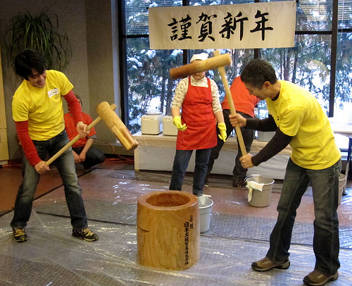  Which japanese traditional dish are the people on the photo doing?