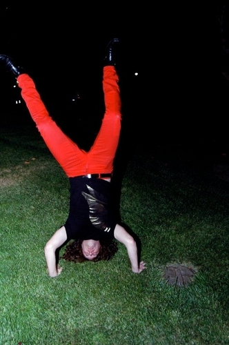 Handstand in red pants