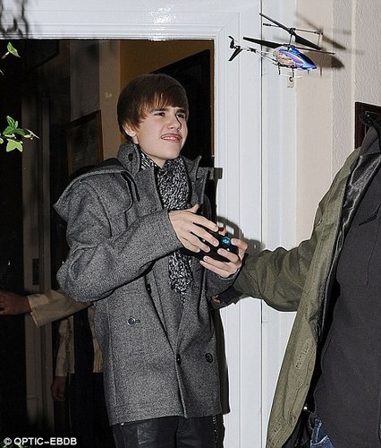 Justin Plays with helicopter at a restraunt in London