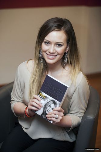  Hilary doing an Autograph Signing of her book 'Elixir', France on February 9,2011