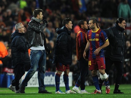  Suspended Barcelona player Gerard Pique (2nd L) stands on the pitch during the UEFA Champions League