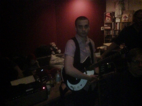  A Dark Shot Of Taylor On The Guitar.