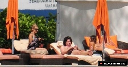 4/28 Relaxes by the pool in Miami