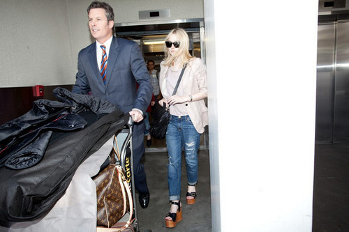  Dakota Fanning's hair flies in the wind as she arrives at LAX (Los Angeles International Airport).