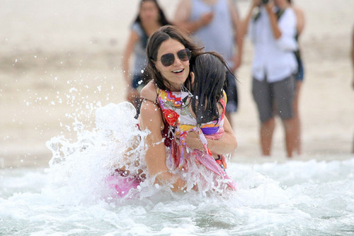 Katie Holmes and daughter Suri visit the beach and splash in the waves outside their Miami hotel