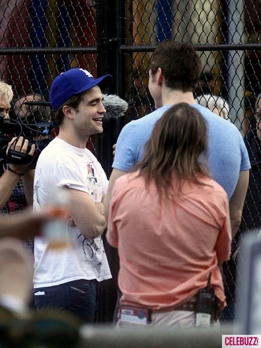  Robert Pattinson on the set of Cosmopolis (with a gun)