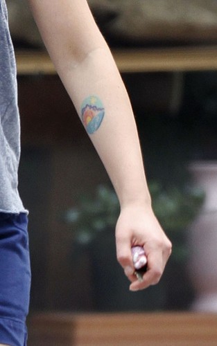 Scarlett Johansson showing off her red hair and tattoos in NYC (July 6).